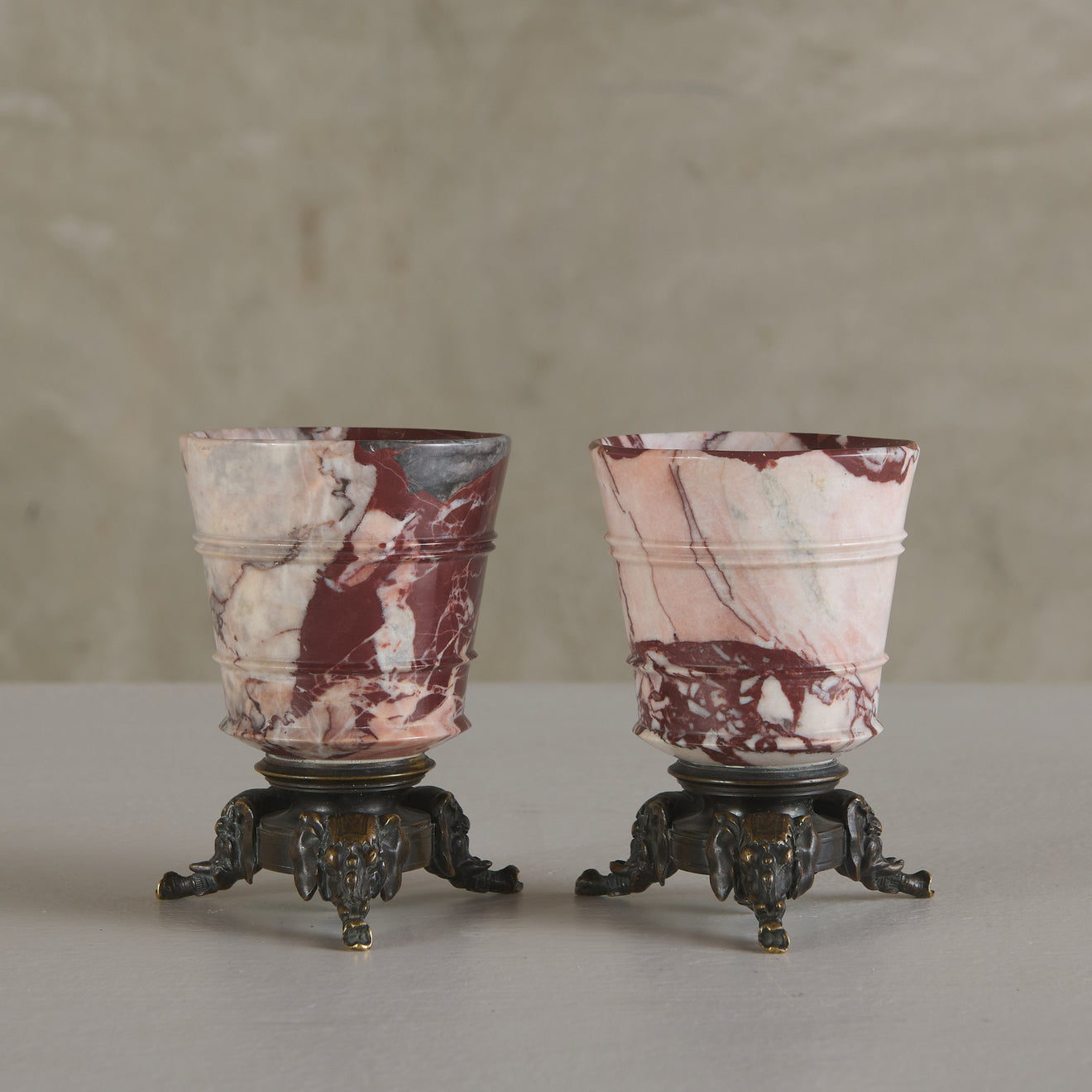 PAIR OF GRAND TOUR URNS WITH ELEPHANT TRIPOD BASES